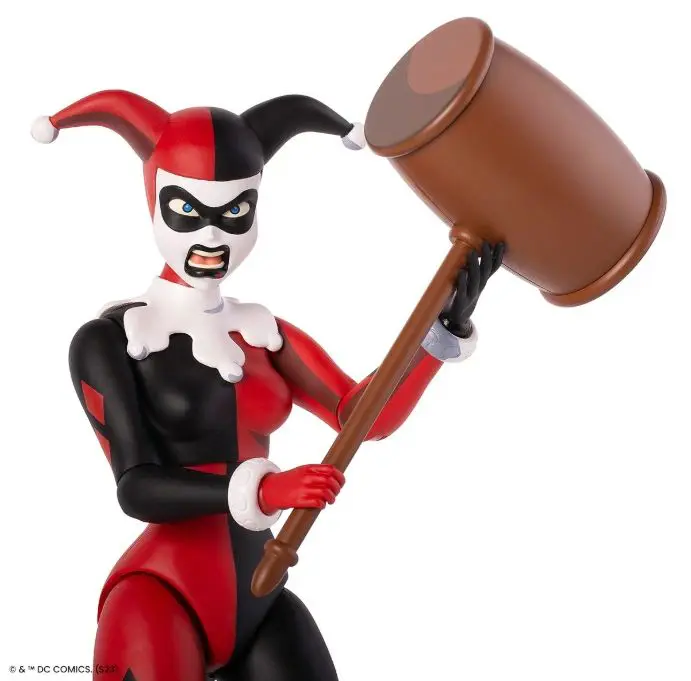 Harlequin character holding large mallet