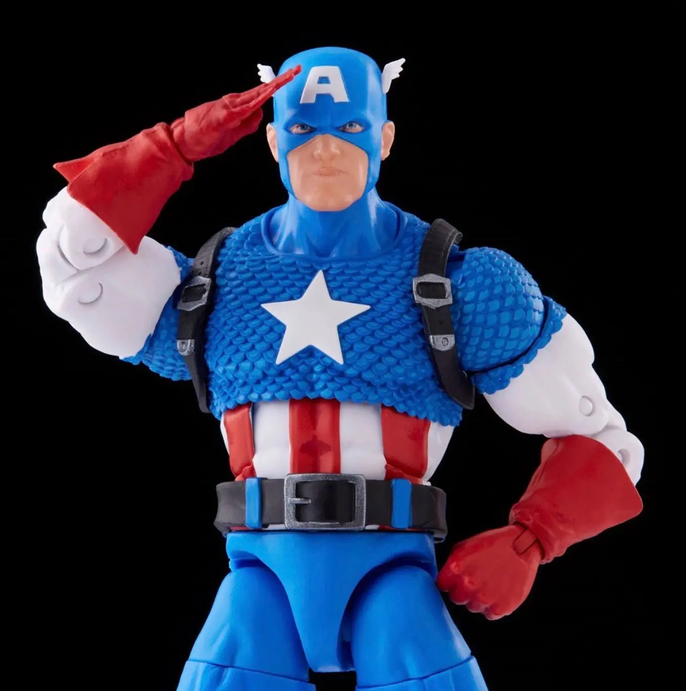Action figure saluting in superhero costume.