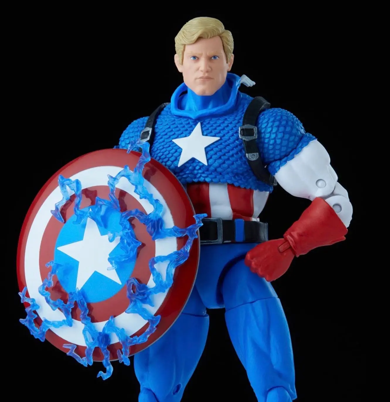 Figurine holding a decorated round shield