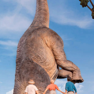 People gazing at large dinosaur