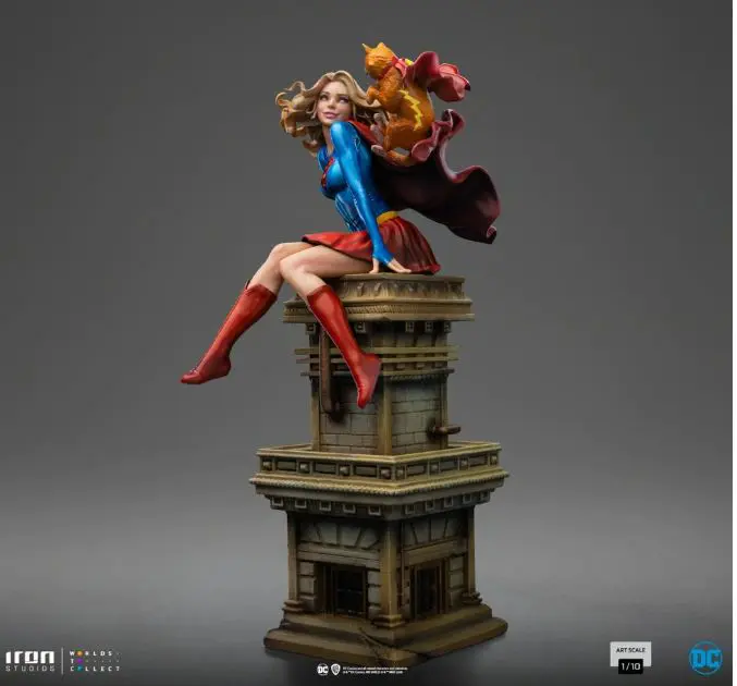 Supergirl statue with a cat companion