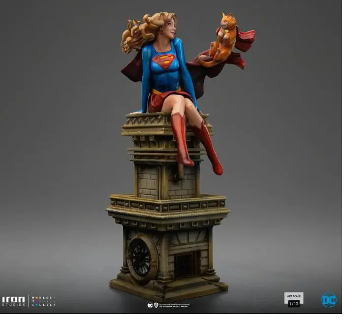 Supergirl statue with cape and cat