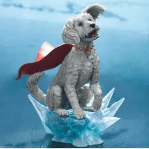 Superhero dog figure with flowing red cape.