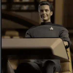 "Action figure of a character seated at table."