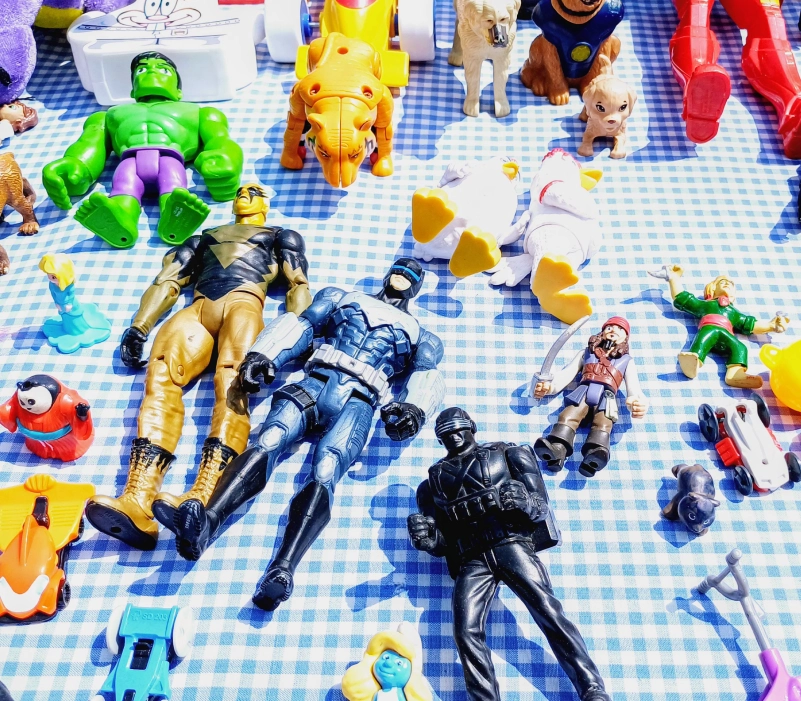 Colorful toys displayed on picnic blanket